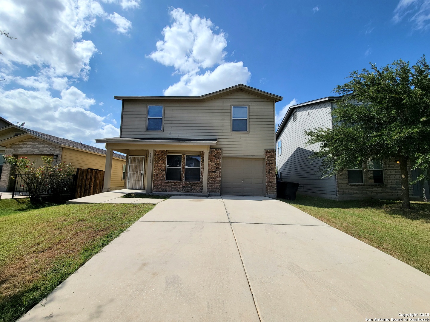 a front view of a house with a yard and garage