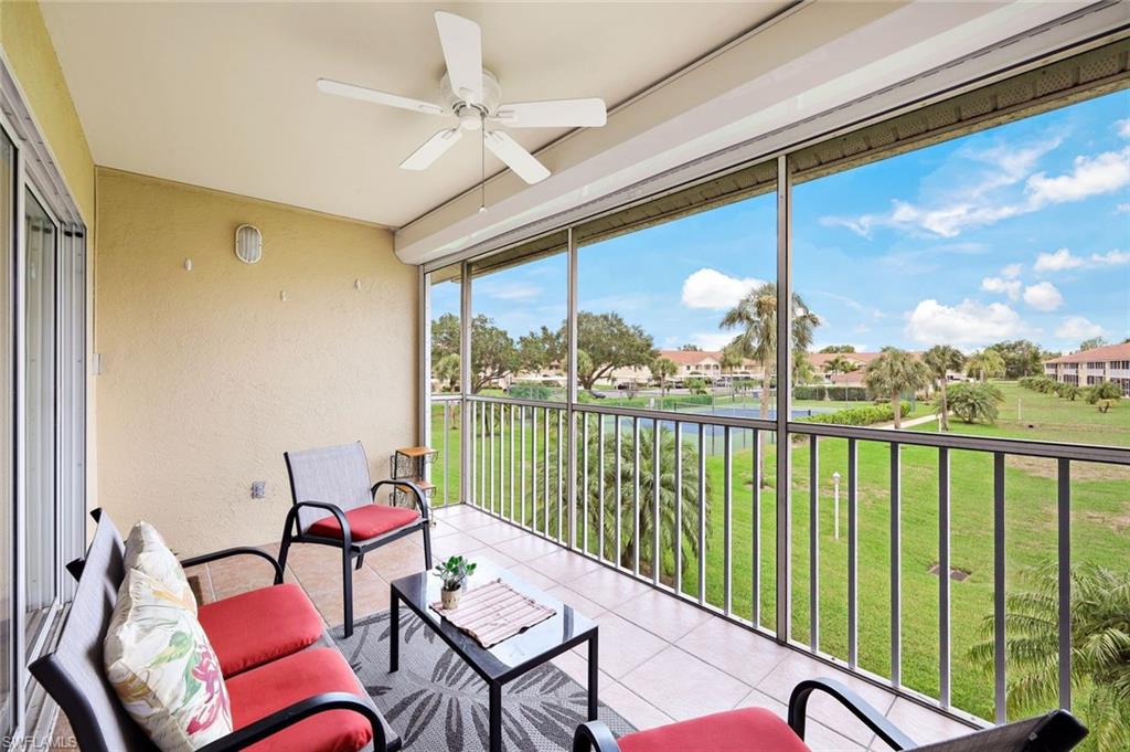 a balcony with furniture and a view of lake