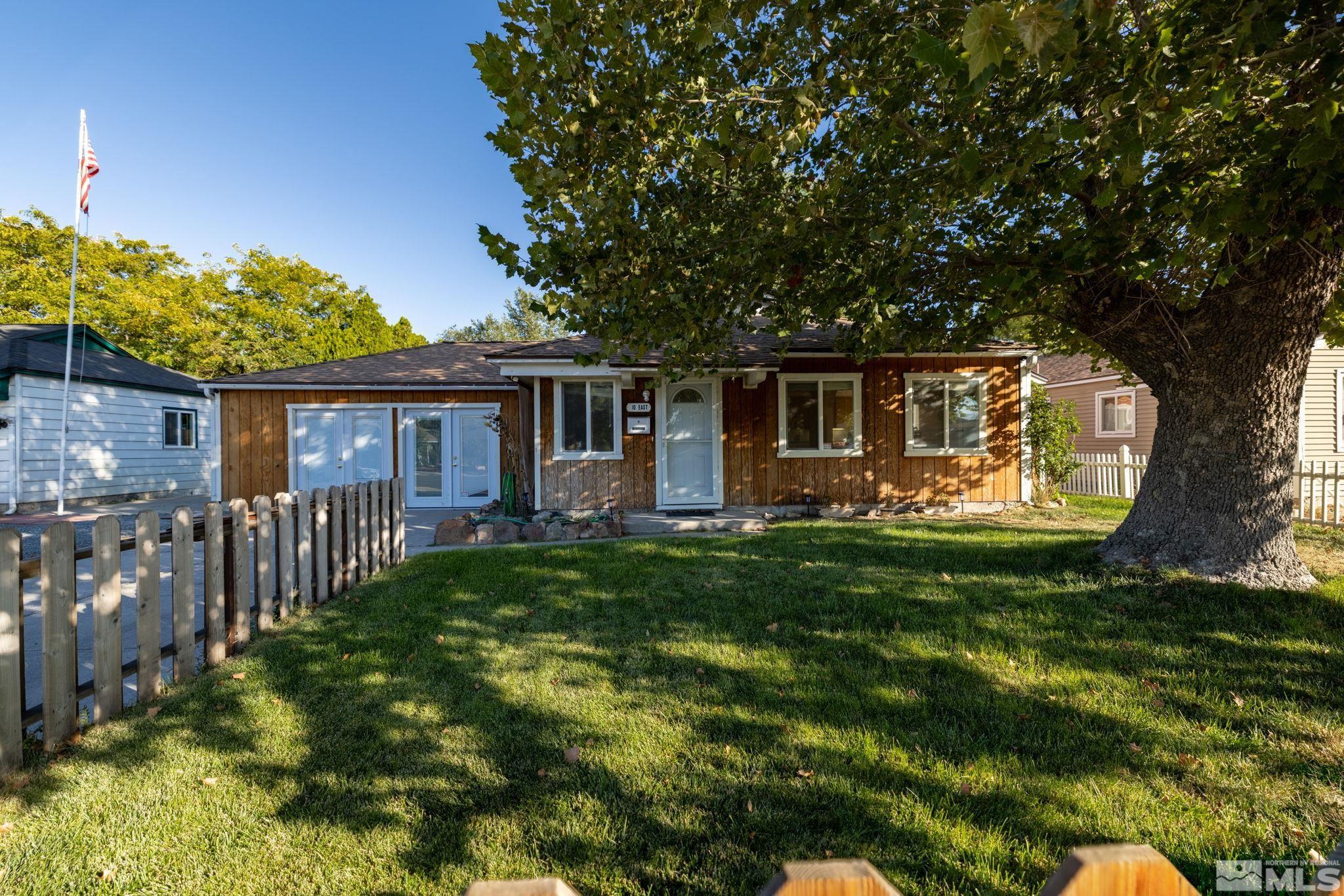 a front view of house with yard and green space