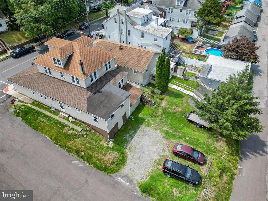 an aerial view of residential house with outdoor space and street view