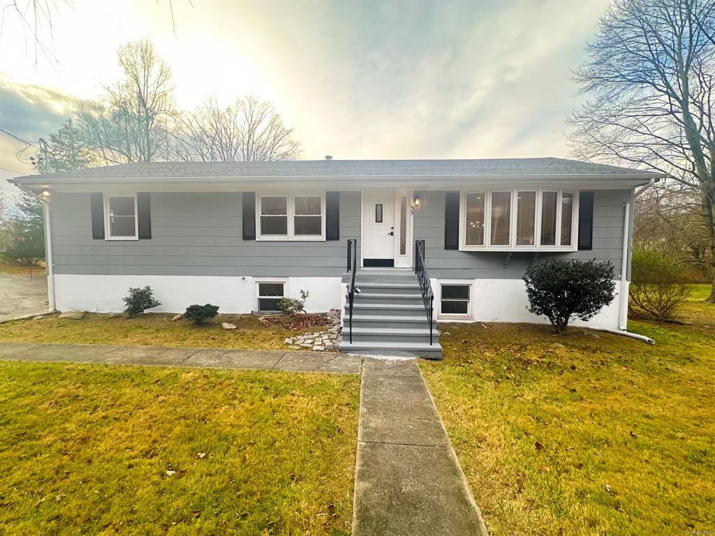 View of front of property featuring a yard