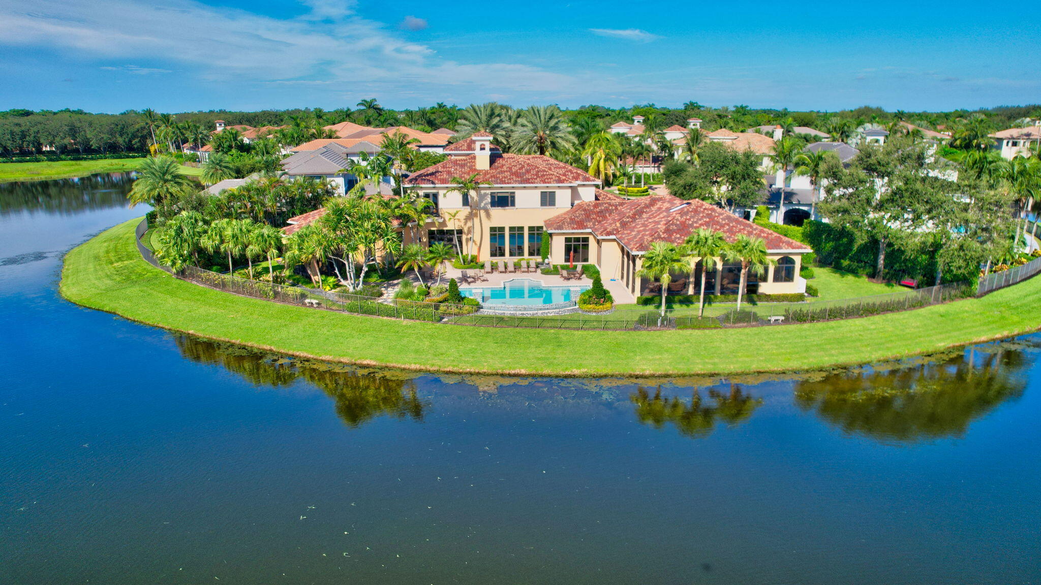 an aerial view of a house with a garden and lake view