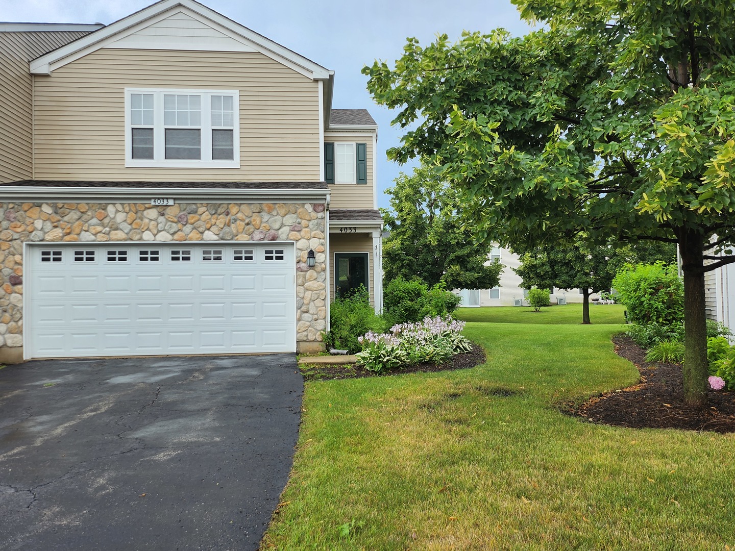 a front view of a house with a yard and garage