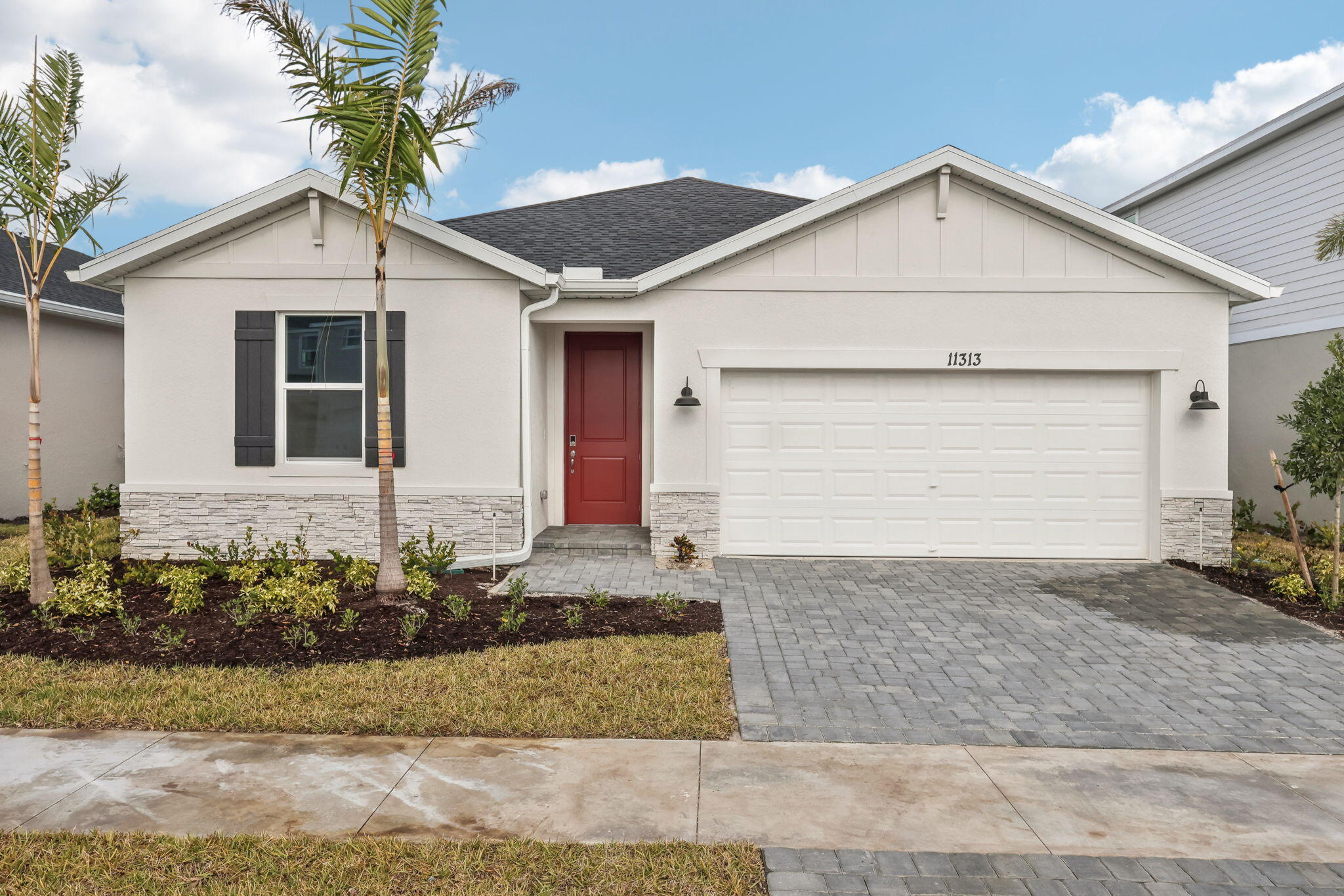 a front view of a house with a yard and garage