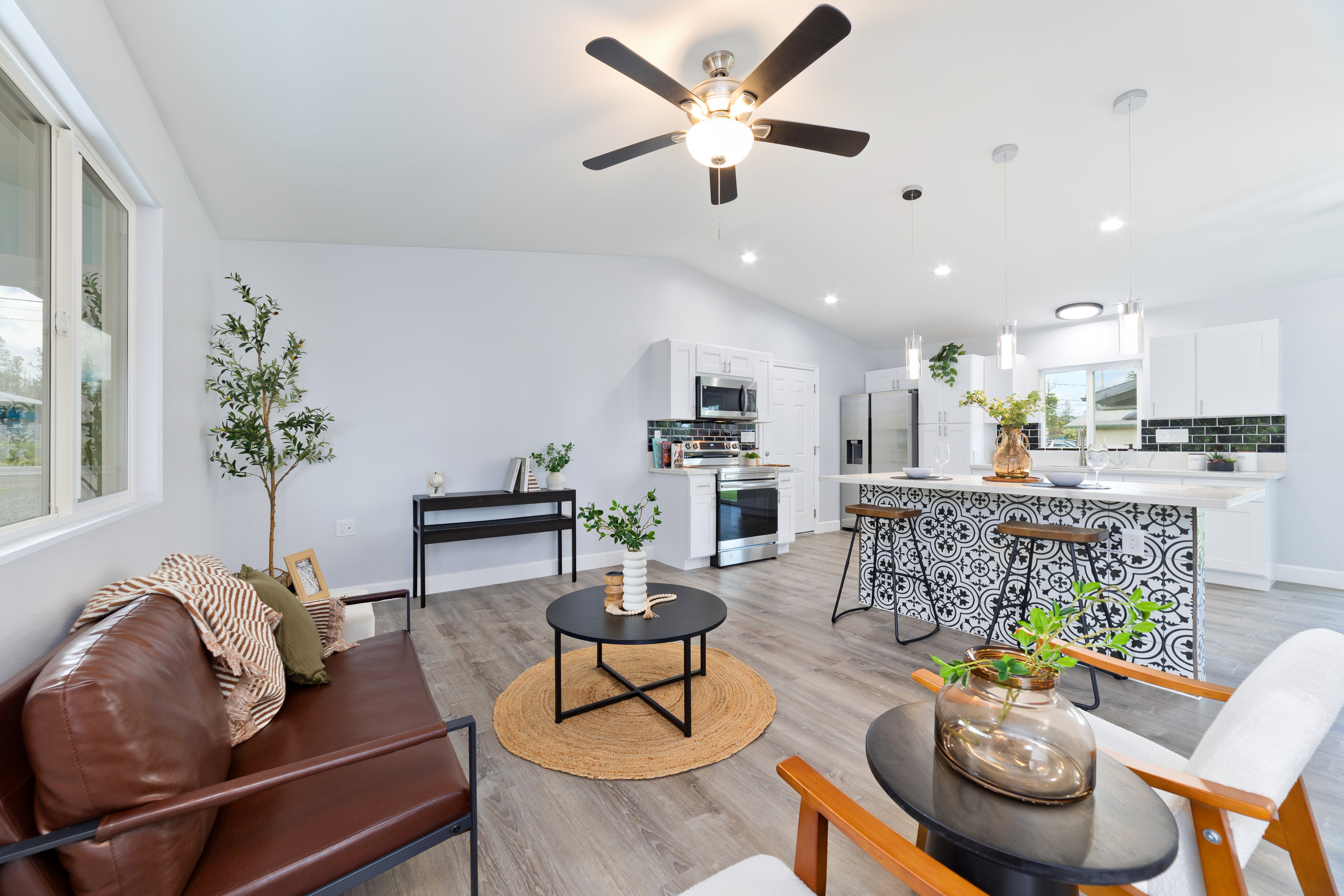 a living room with furniture and kitchen view