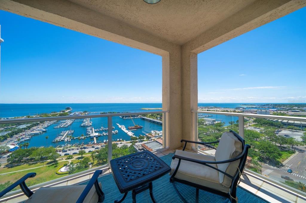 a view of a balcony with chair and table