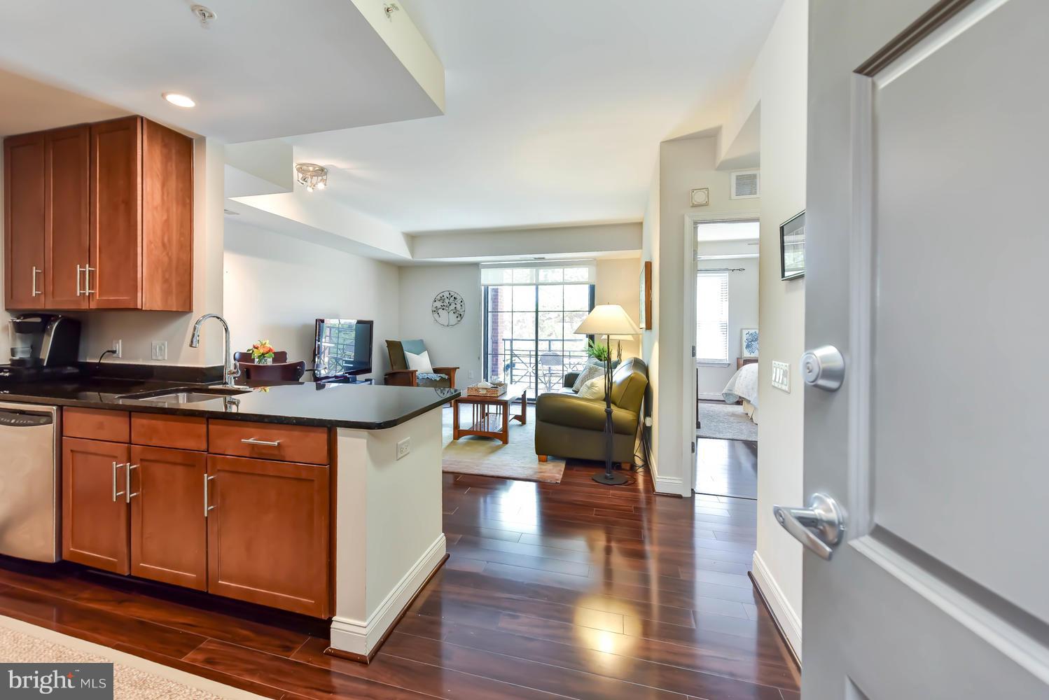 a kitchen with sink refrigerator and cabinets