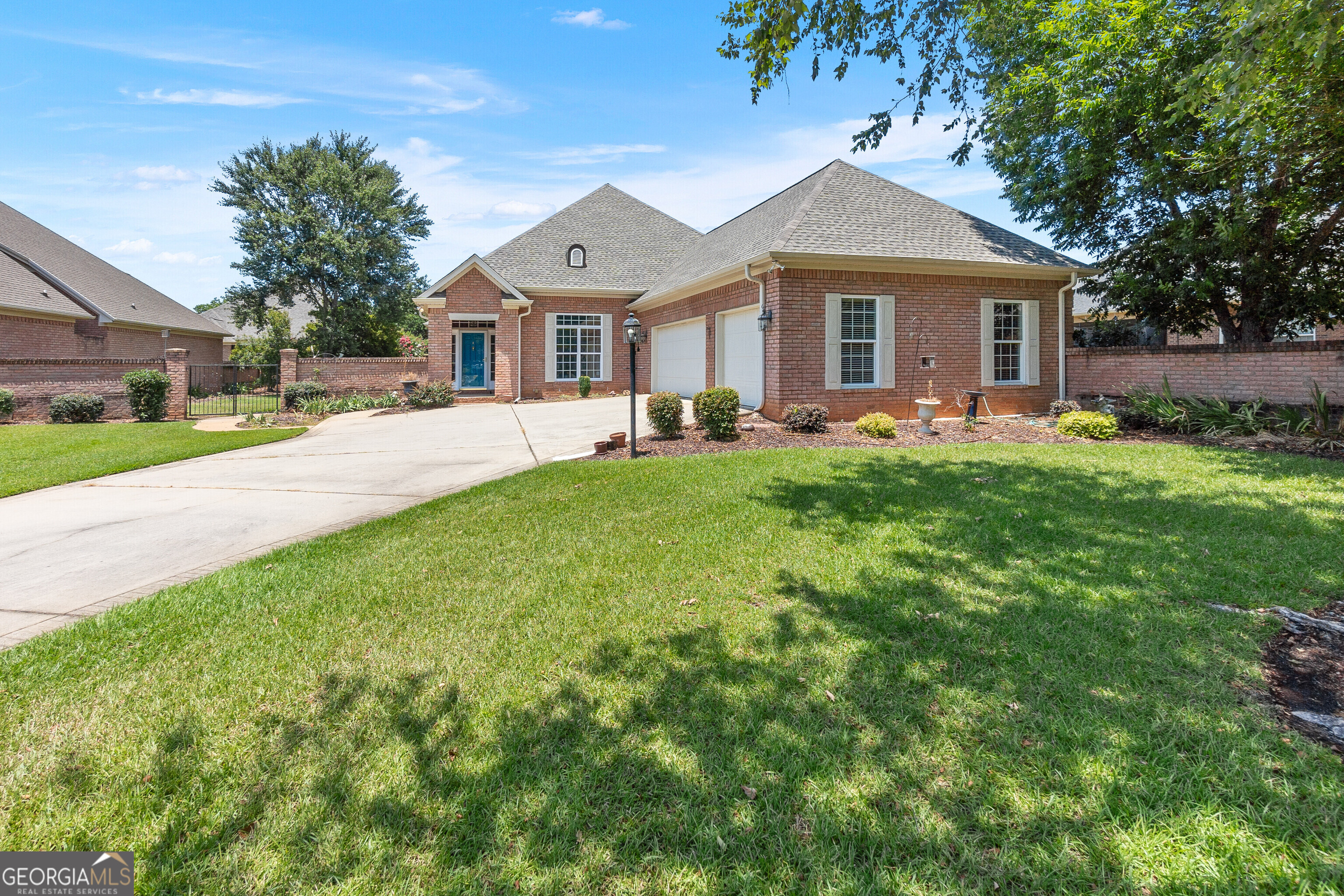 a front view of house with yard and green space