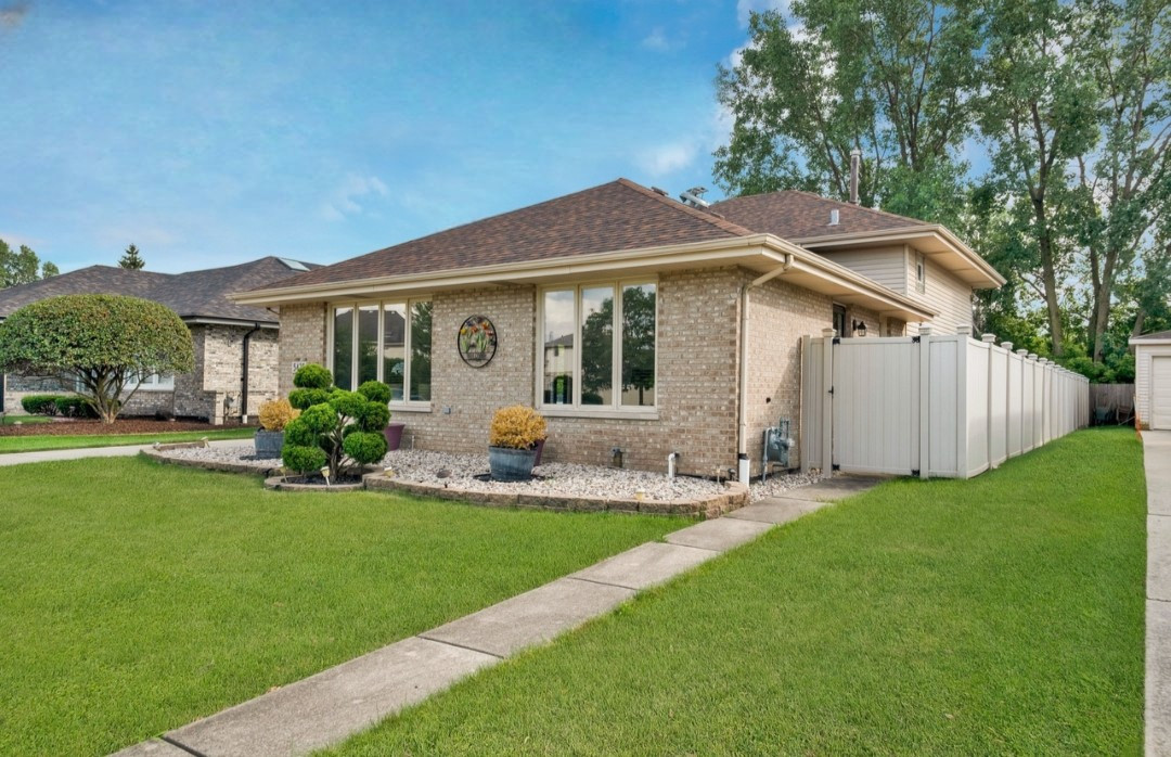 a view of a house with a yard and sitting area