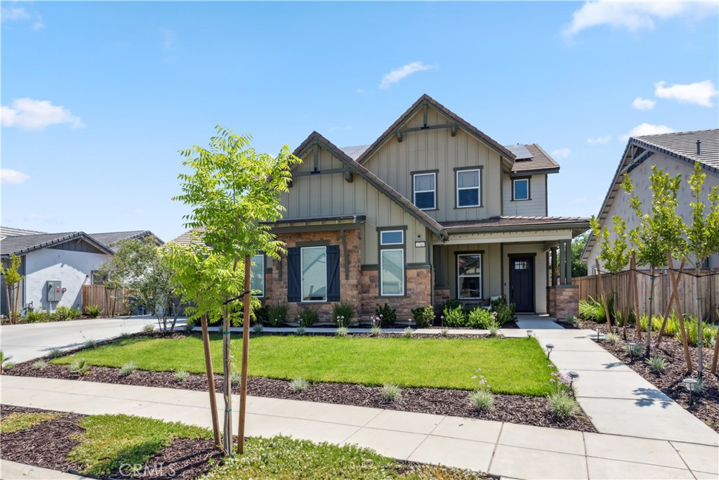 a front view of house with yard and green space