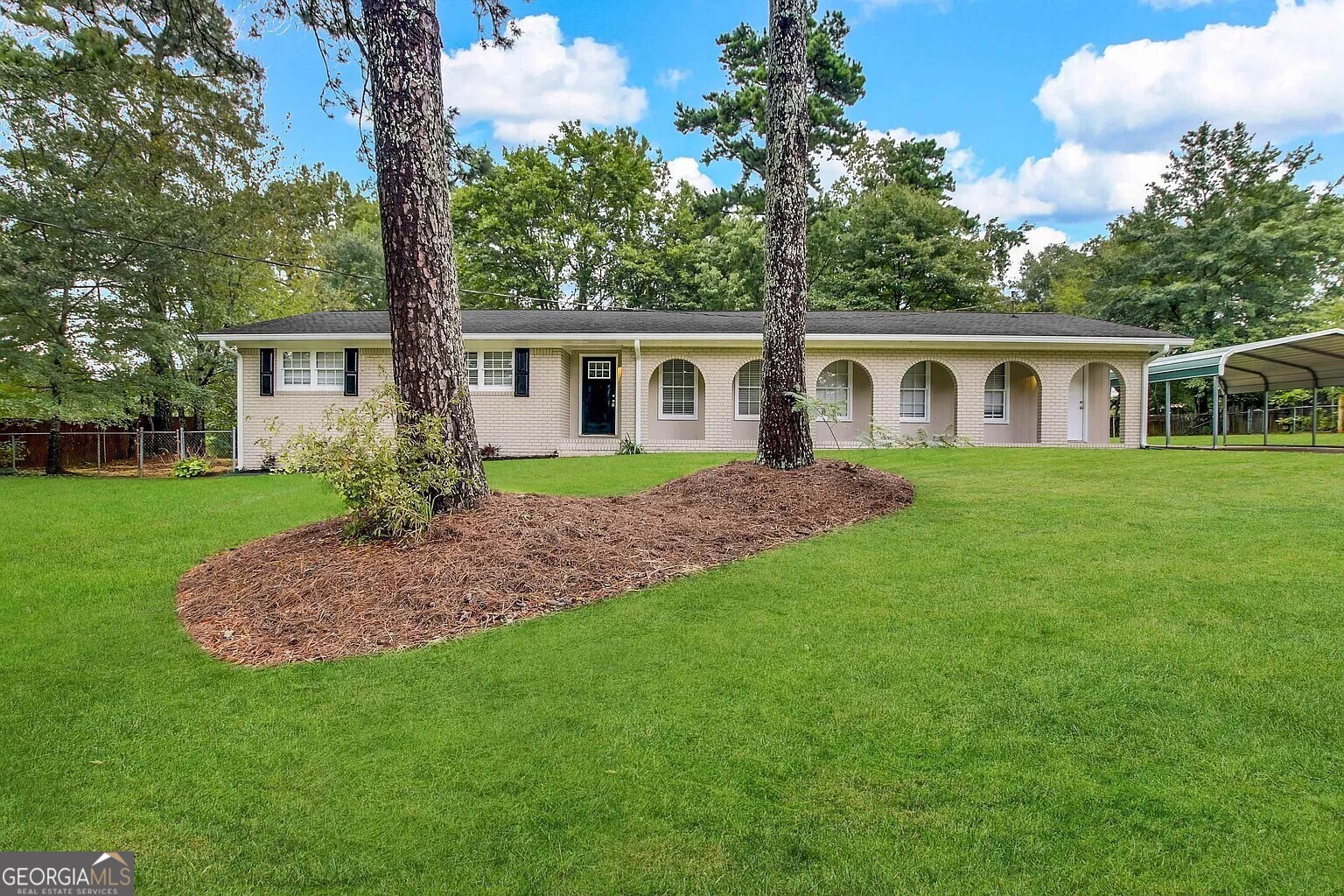 a front view of house with yard and green space