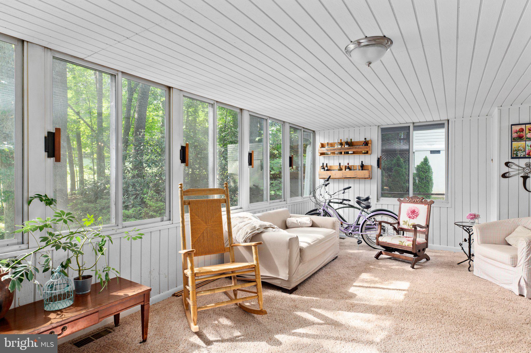 a bedroom with furniture and a large window