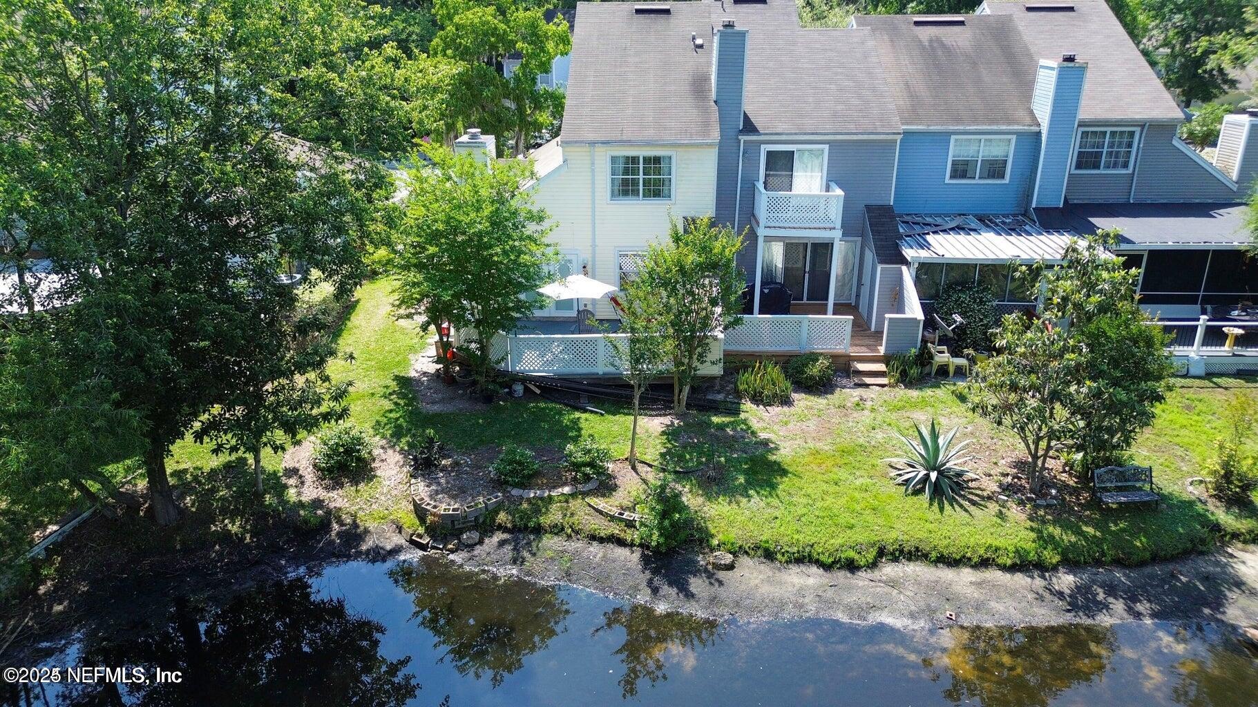 a view of a house with a yard and plants