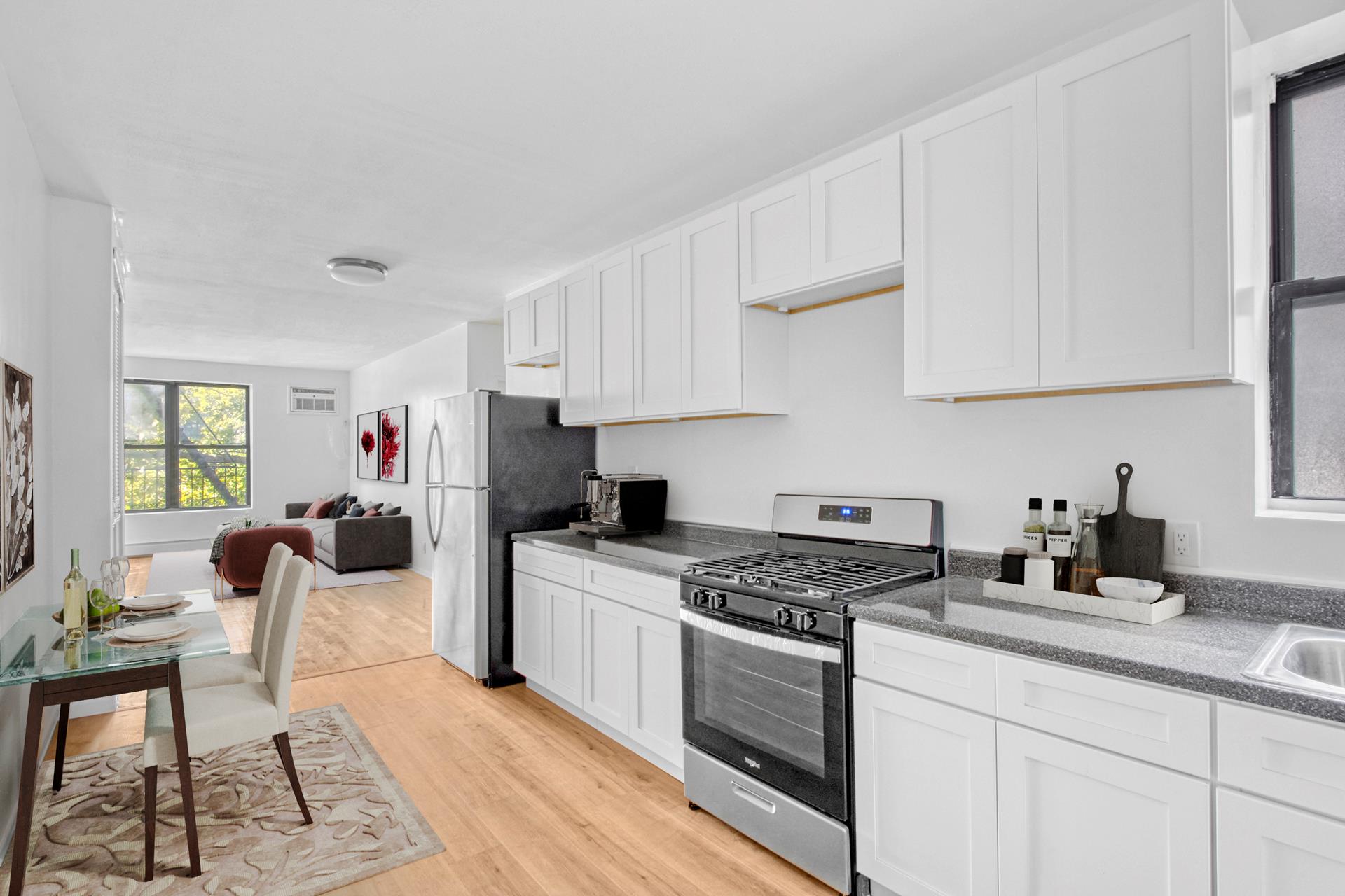 a kitchen with granite countertop a sink a stove and cabinets