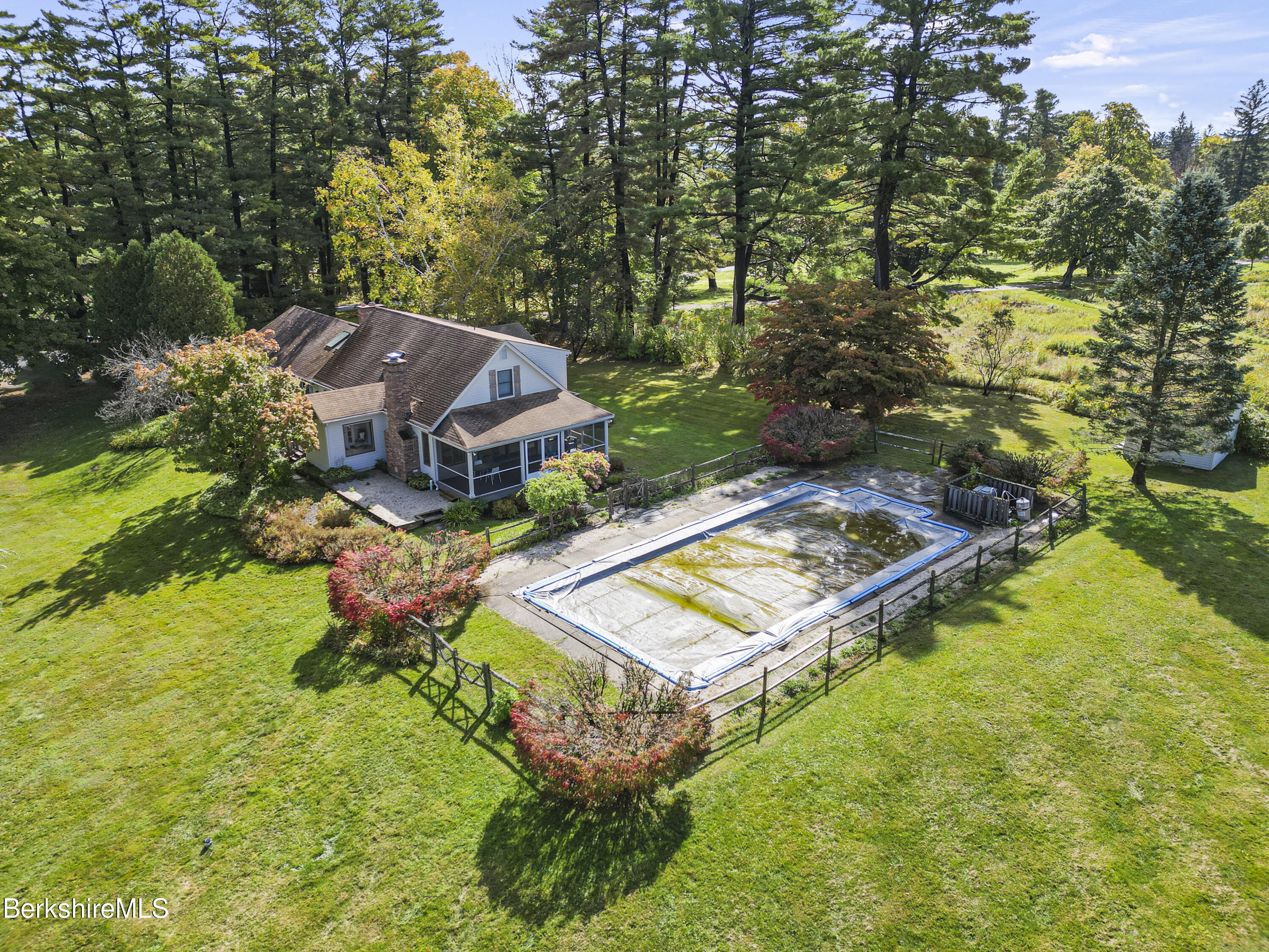 an aerial view of a house with garden space and street view