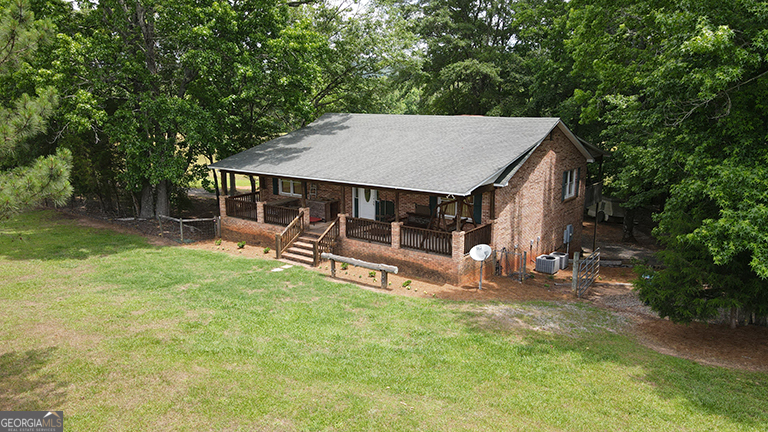 a view of a house with backyard porch and sitting area