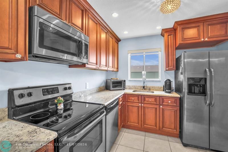 a kitchen with a sink stove and microwave