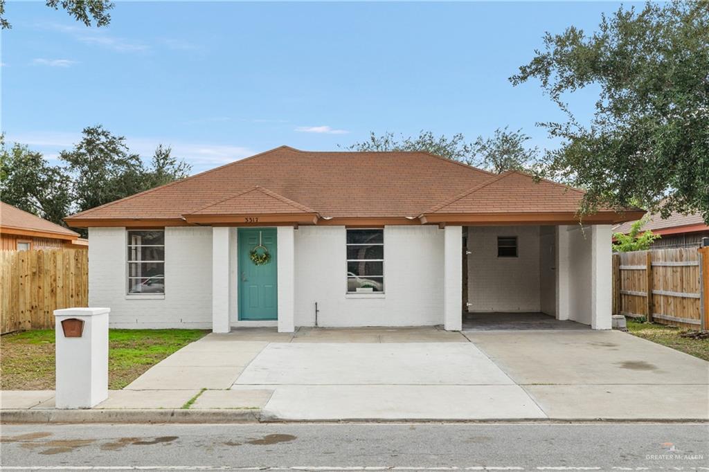 View of front of property featuring a carport