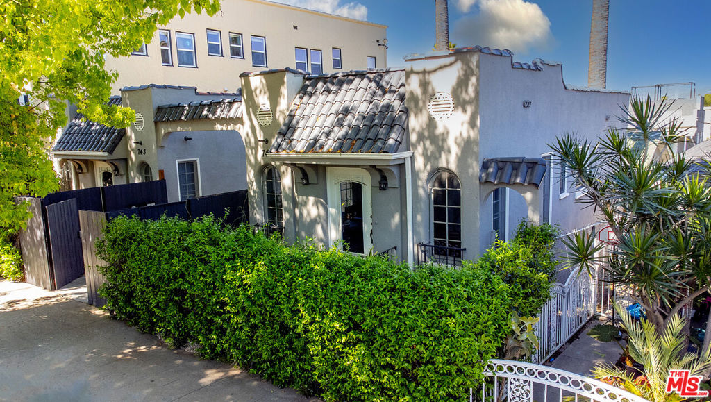 front view of a house with potted plants