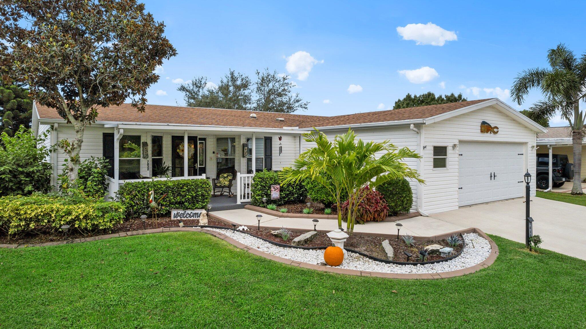 a view of a house with backyard and sitting area