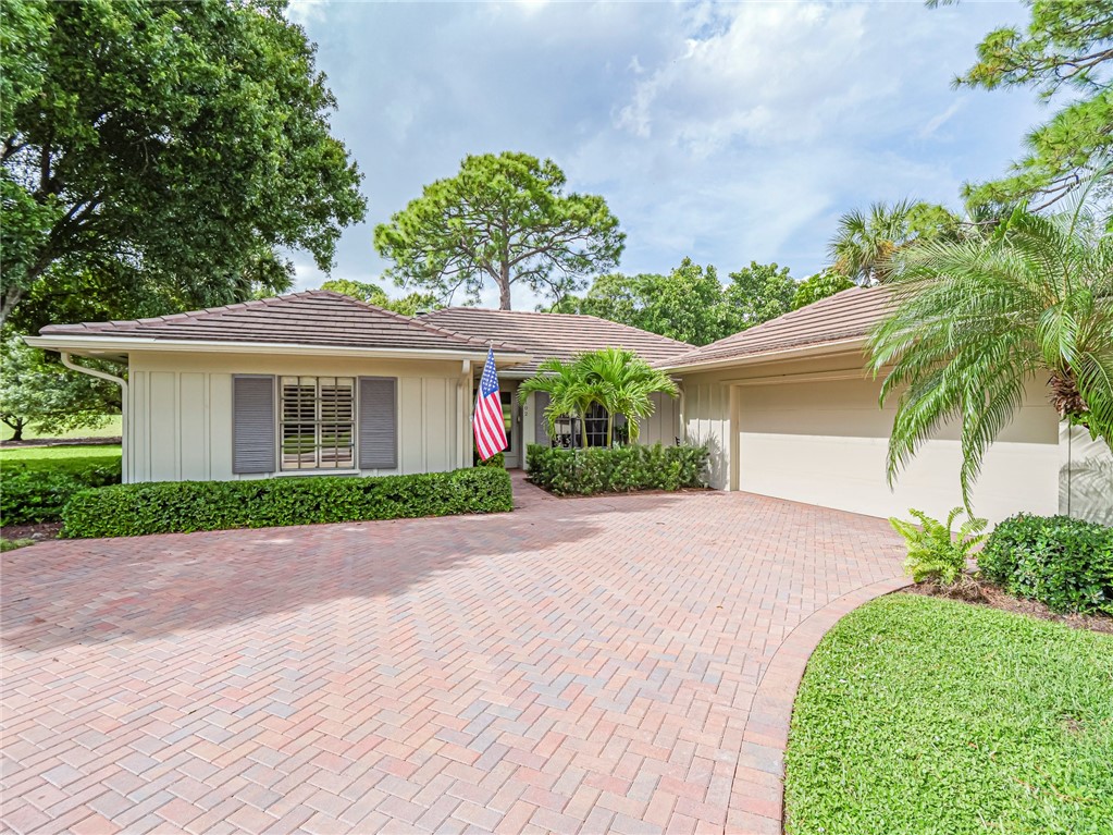 a front view of a house with a yard and a garage