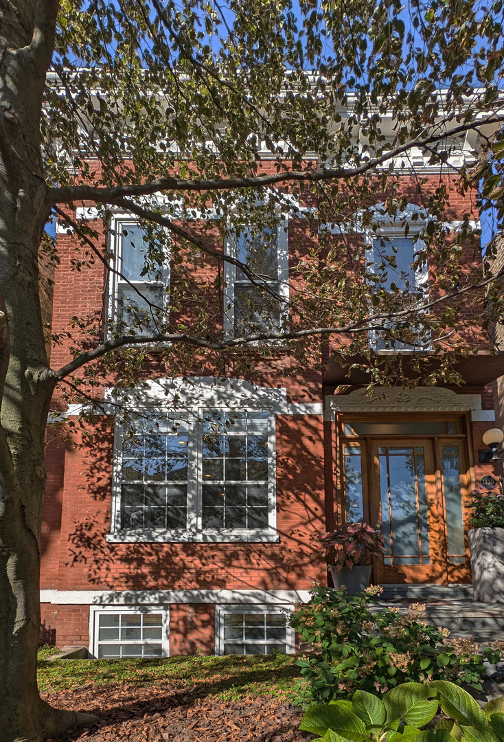 front view of a house with a tree