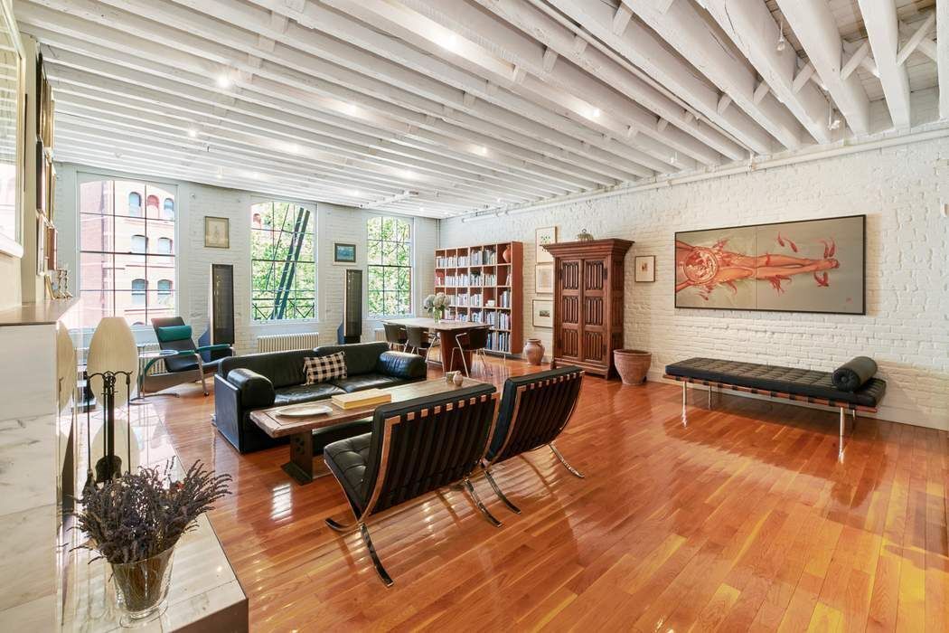 a living room with furniture a wooden floor and pool table