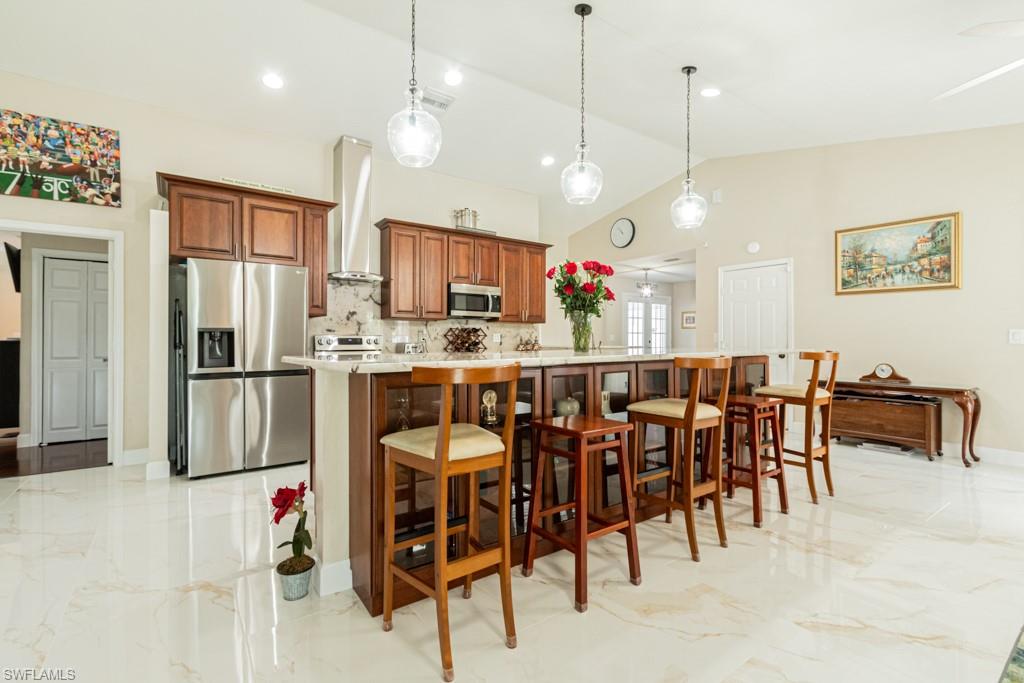 a large kitchen with a table and chairs