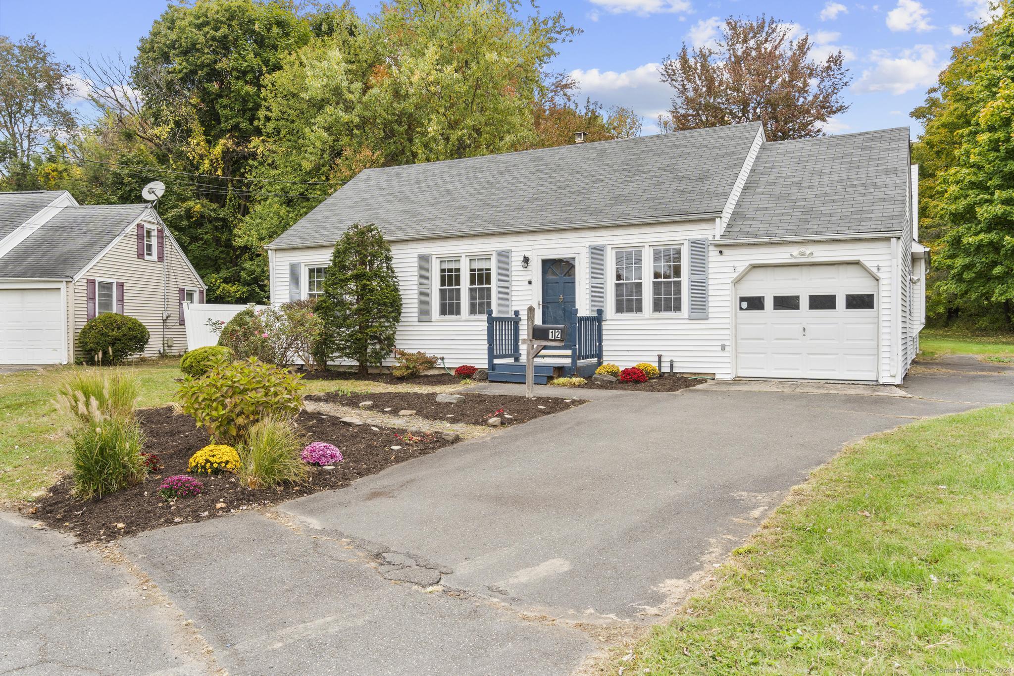 a front view of a house with a yard and a garage