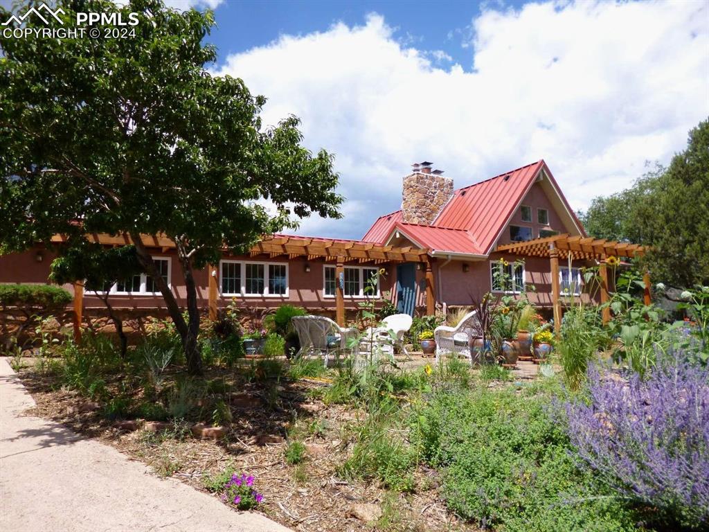 View of front of property with a pergola