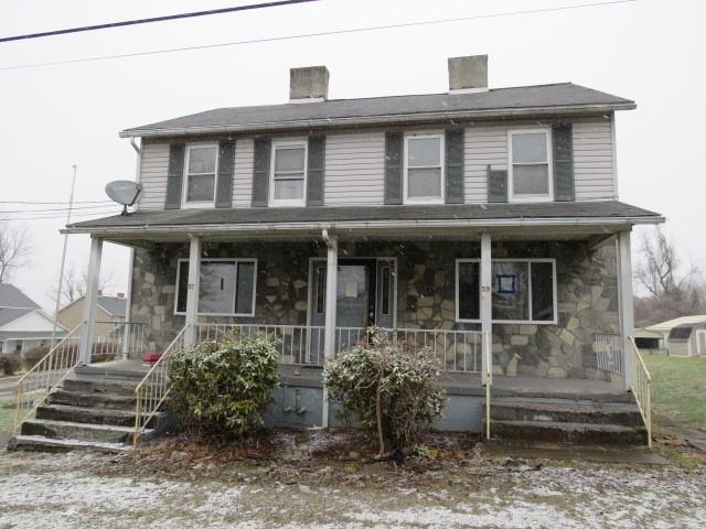 a front view of a house with plants