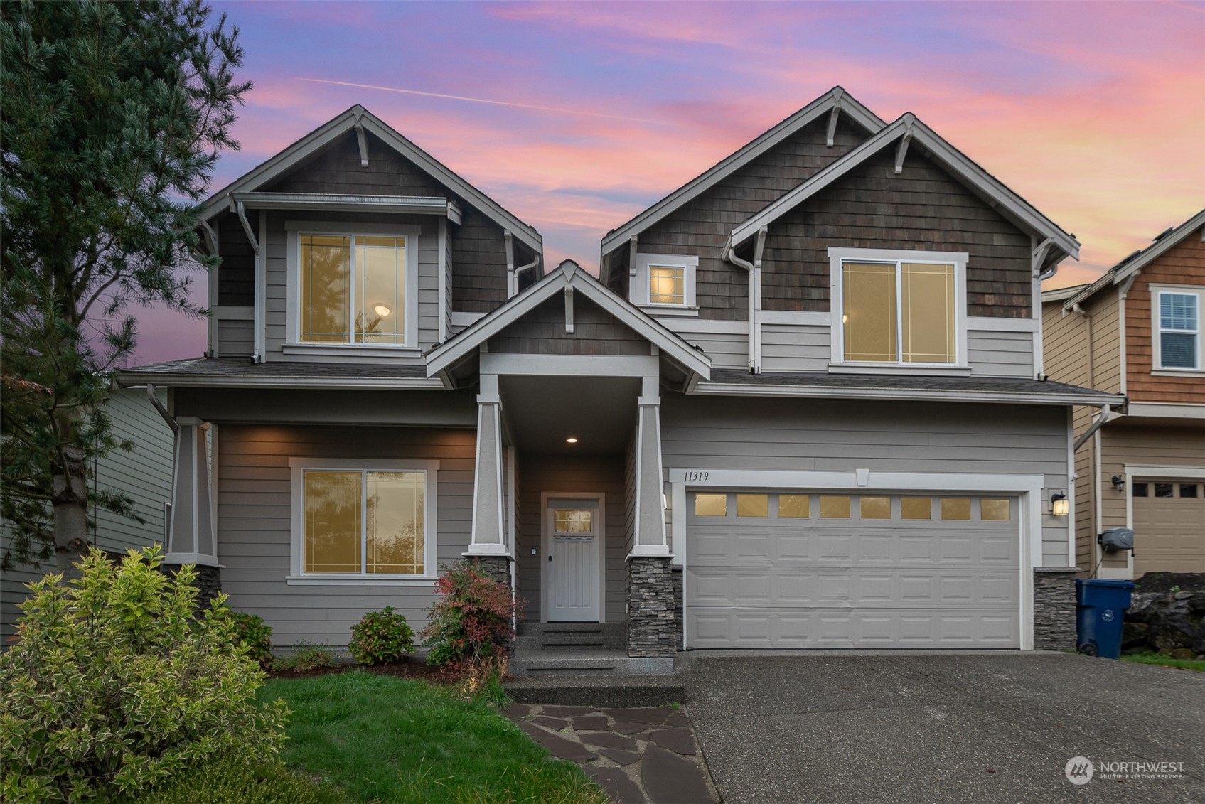 a front view of a house with a yard and garage