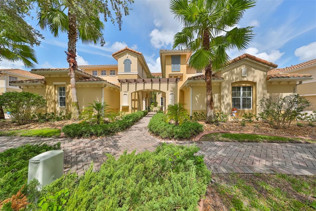 The lovely custom paved parking pads, sidewalks and landscaping add a Mediterranean element to the condo. This tree lined street is one of the prettiest in Sun City Center