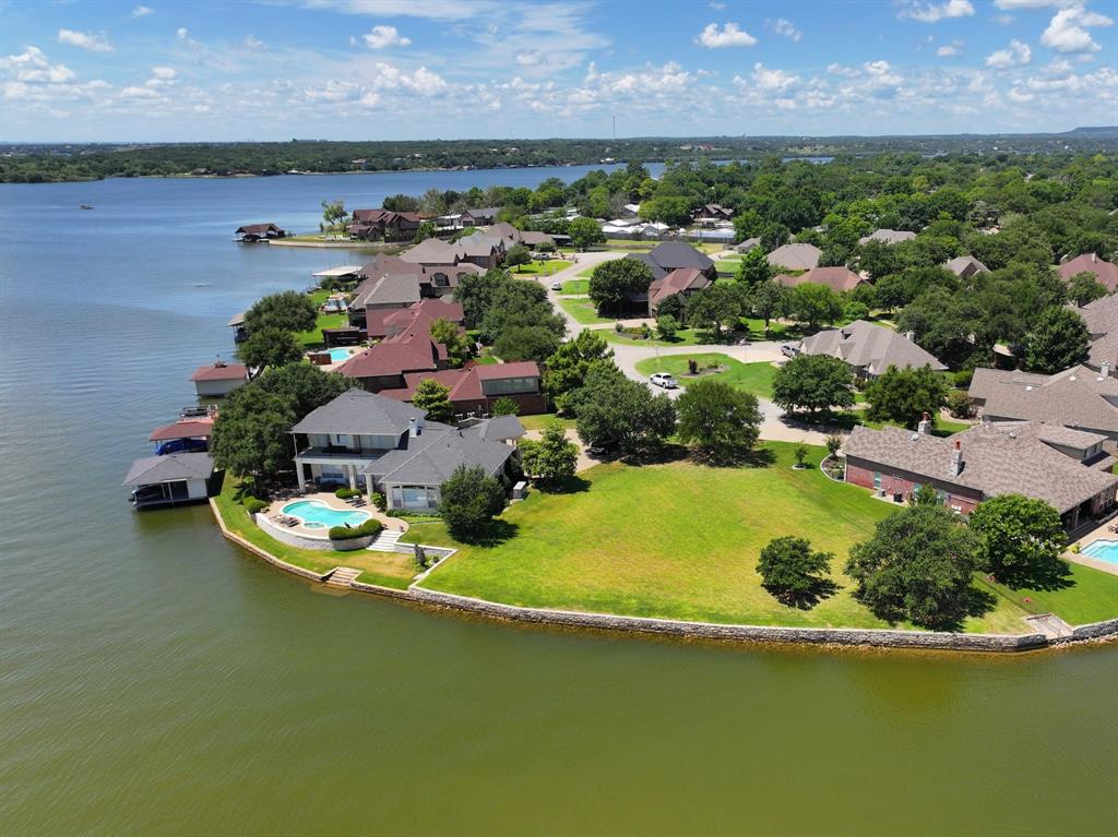 an aerial view of a house with a garden and lake view