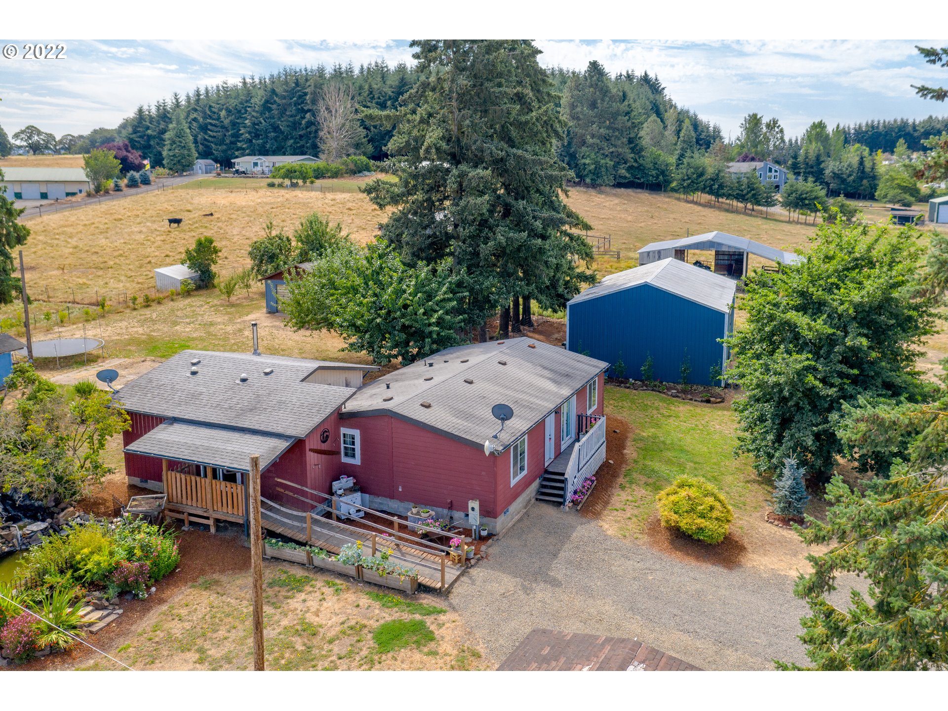 an aerial view of a house with garden space and trees