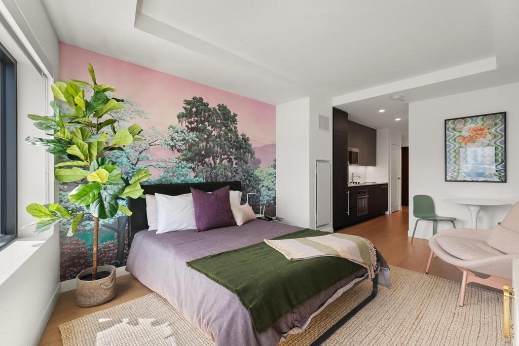 a bedroom with a bed potted plant with the outer view