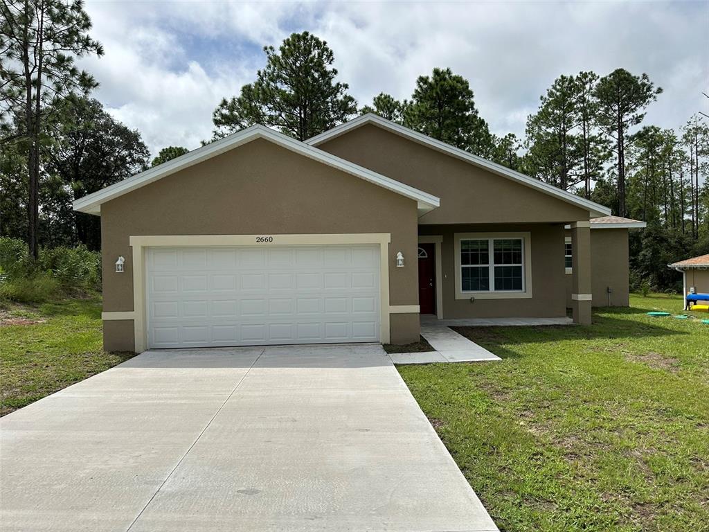 a front view of house with yard and green space