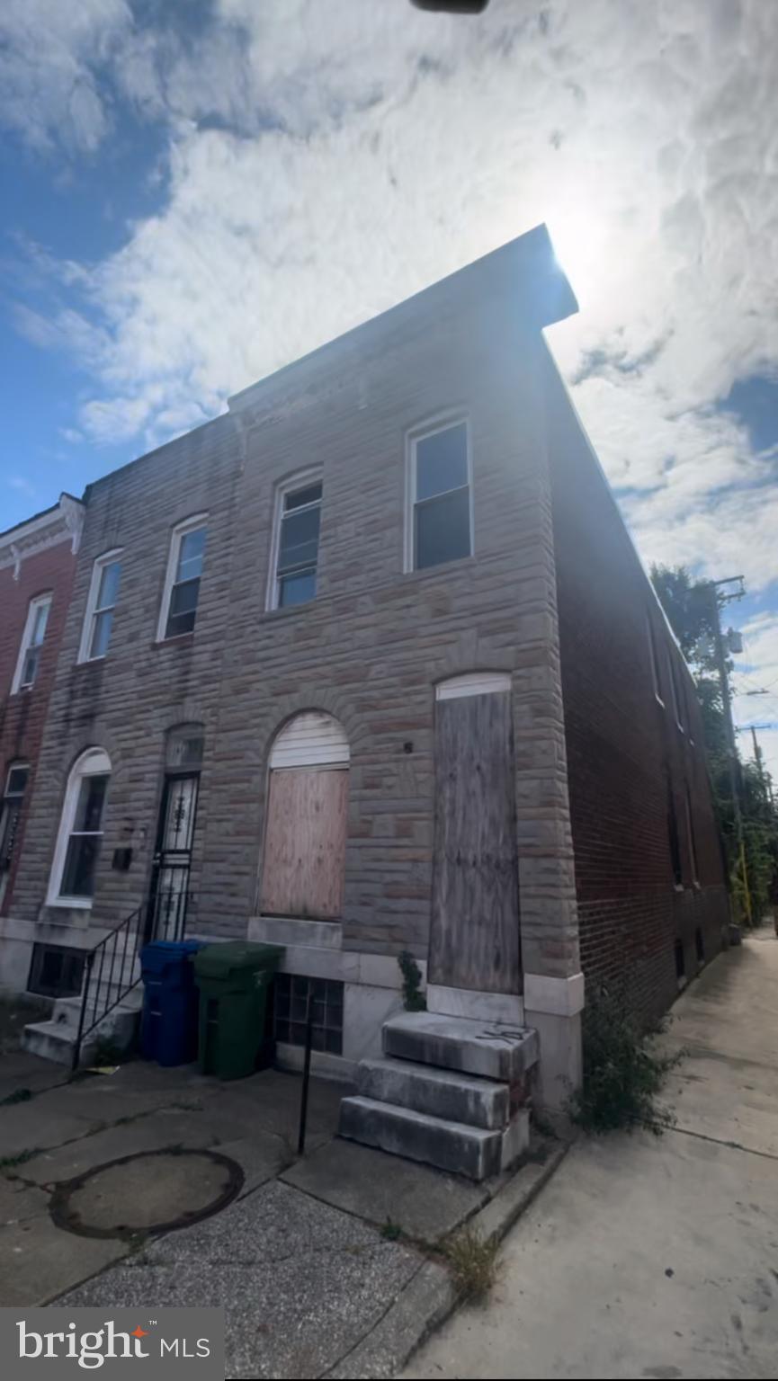 a brick building with a yard in front of it