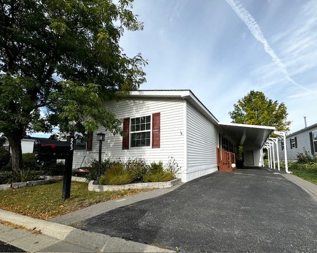 a view of a house with a yard and large tree