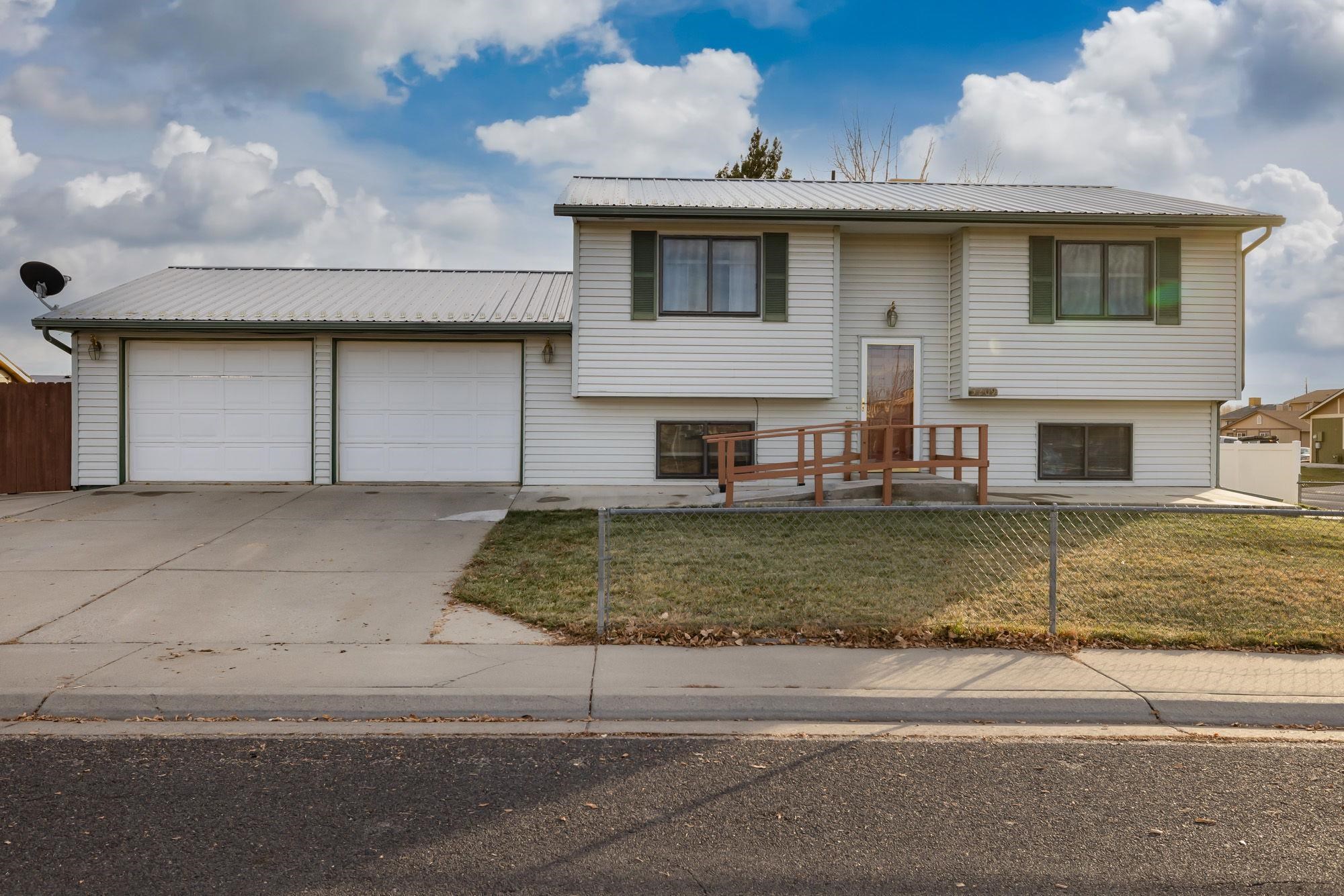 a front view of a house with garage