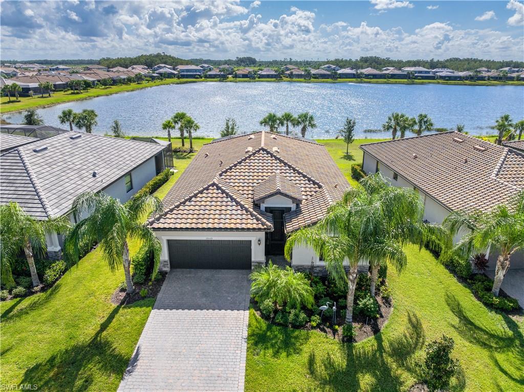 Birds eye view of property with a water view