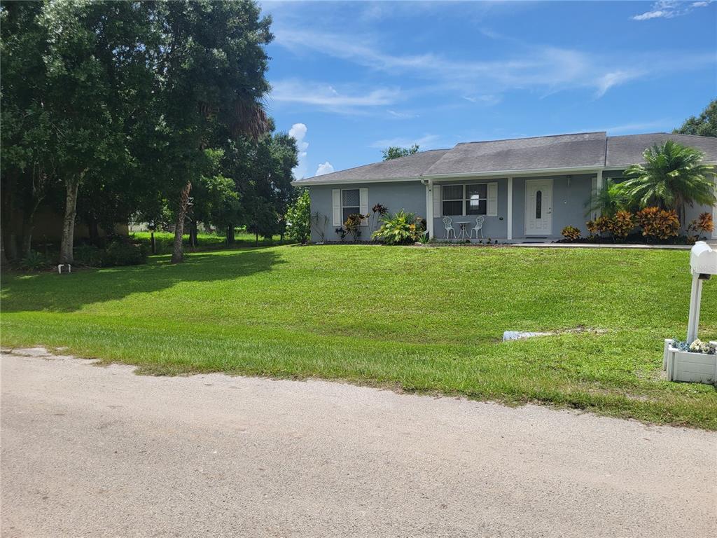 a front view of house with yard and green space