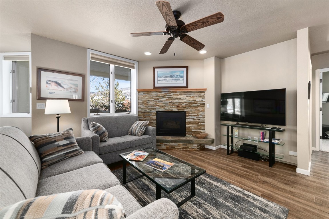 a living room with furniture a flat screen tv and a fireplace