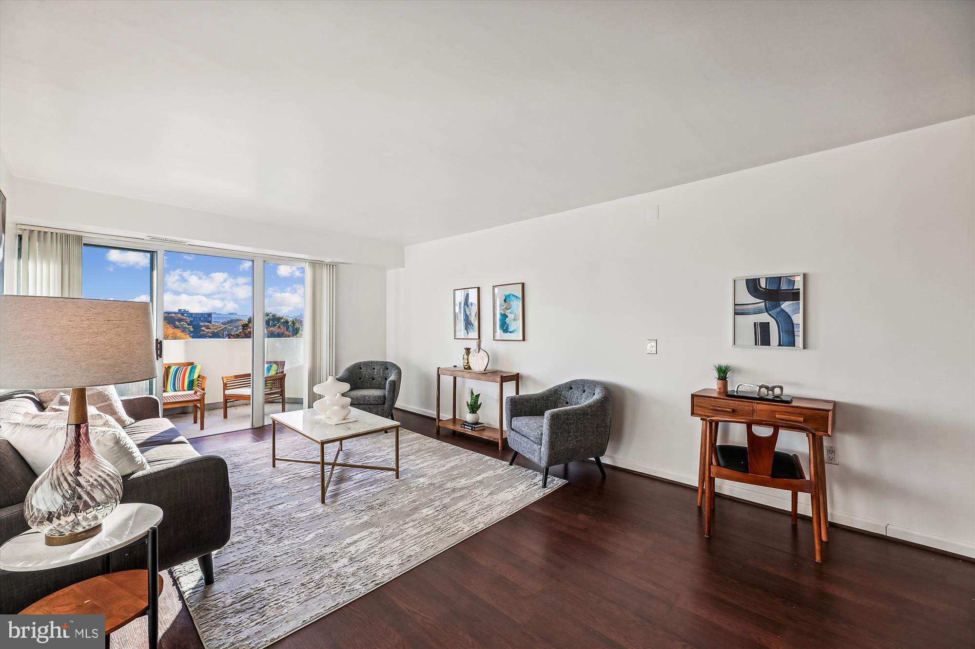 a living room with furniture and wooden floor