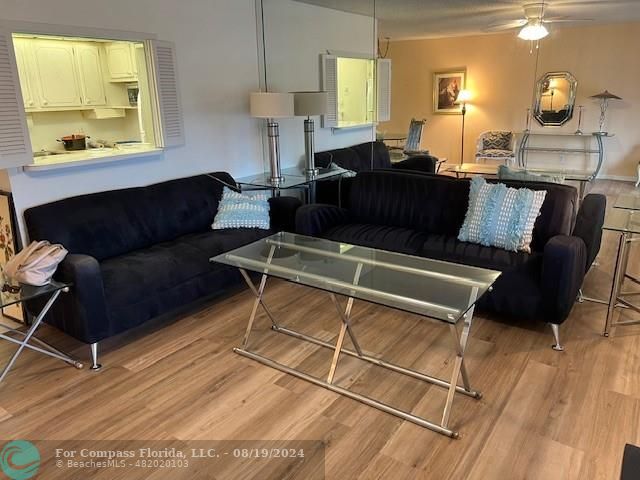 a living room with furniture window and wooden floor