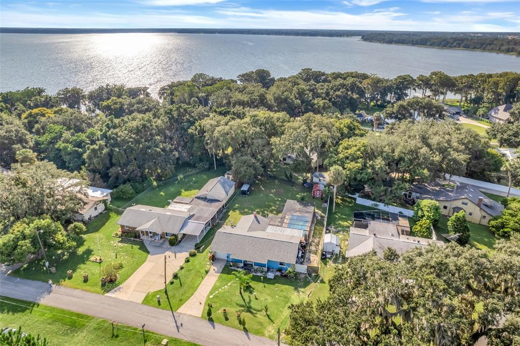 an aerial view of a house with a lake view