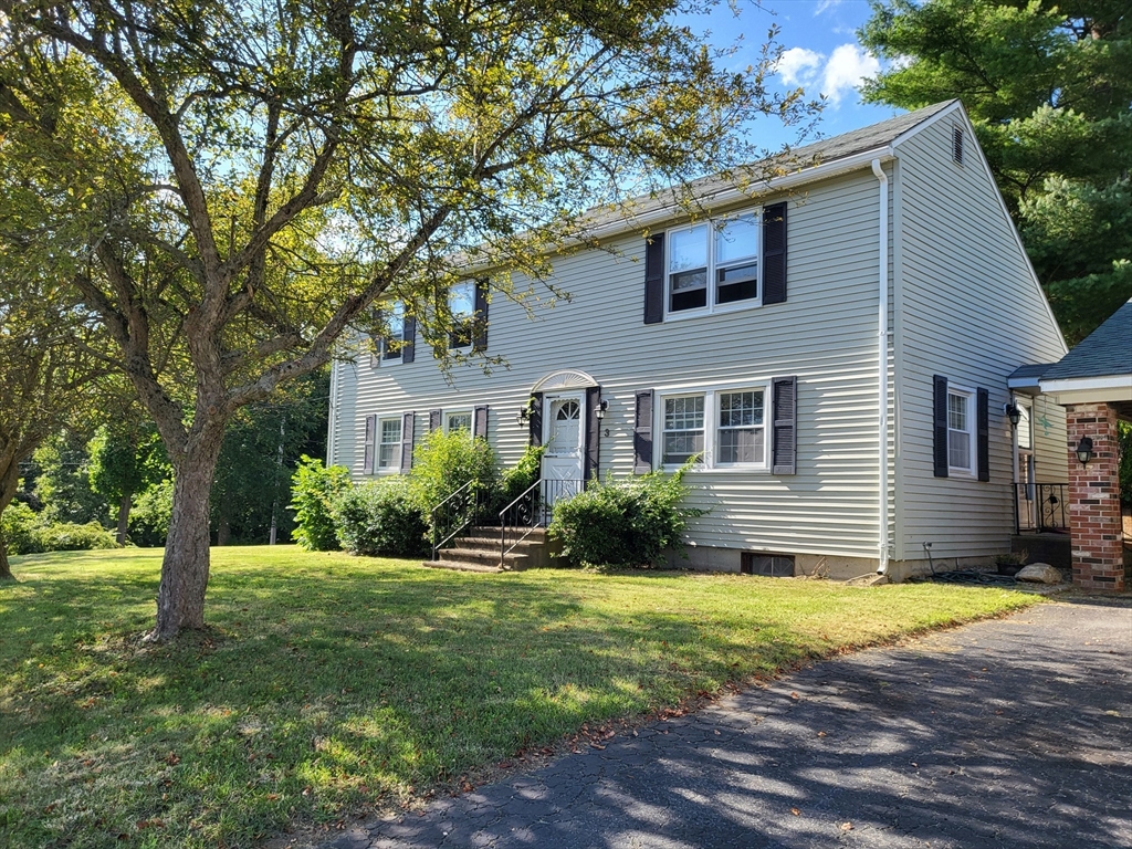 a front view of a house with a yard and porch