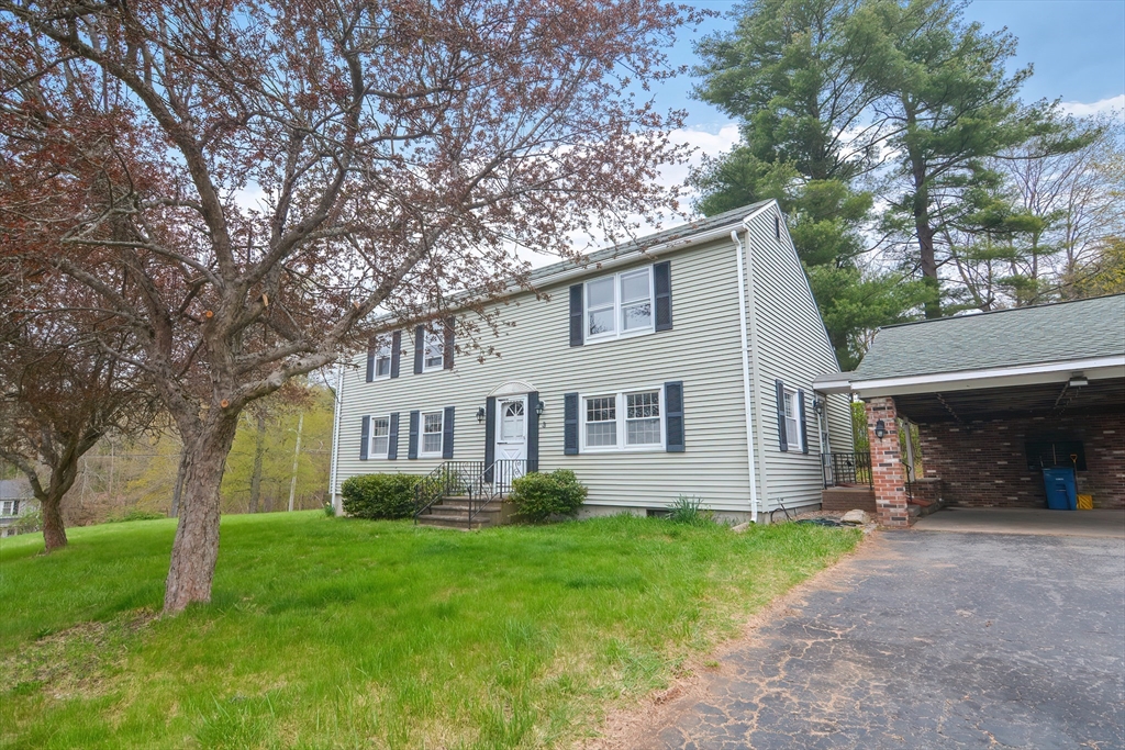 a front view of house with yard and green space