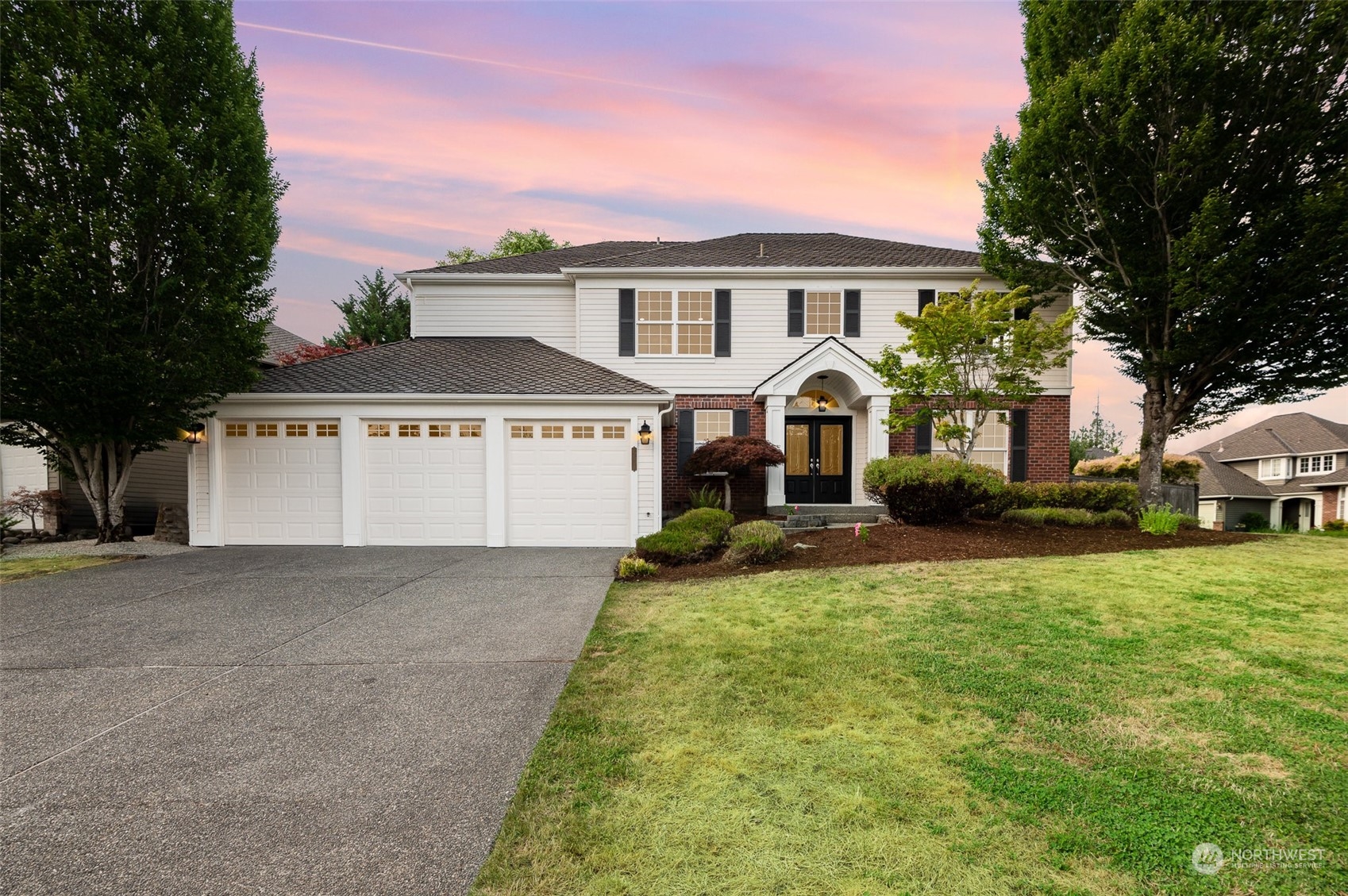 a front view of a house with a yard and garage