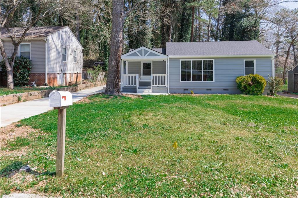 a front view of a house with a yard and porch